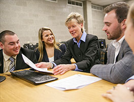 Business students with teacher in class
