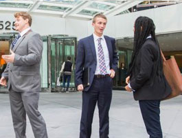Students standing on a city street talking
